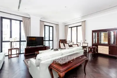 Luxurious living room with elegant furniture and large windows in a high-rise apartment.