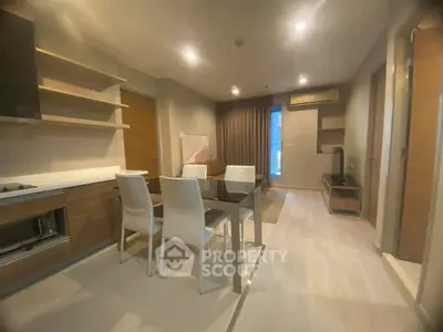 Modern open-plan living and dining area with sleek kitchen and stylish decor.
