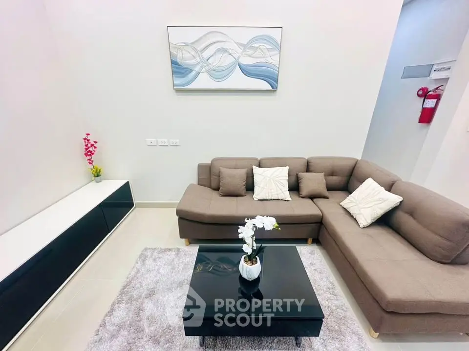 Modern living room with stylish sectional sofa and elegant decor.