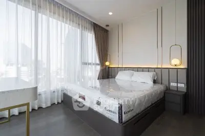 Luxurious modern bedroom with floor-to-ceiling windows and elegant lighting fixtures.