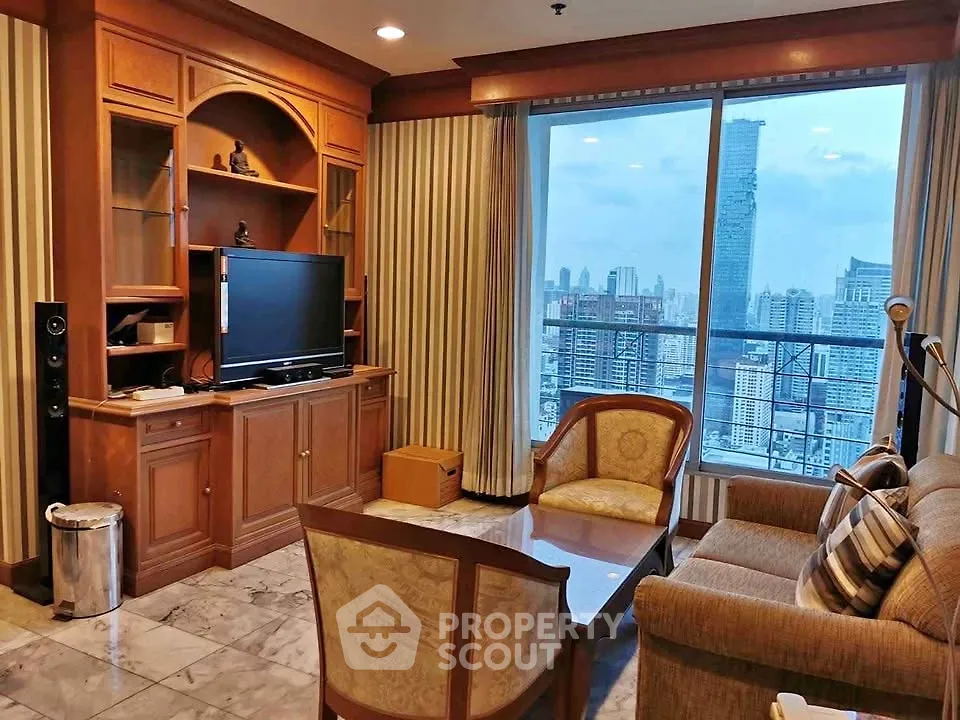 Luxurious living room with stunning city view, elegant furniture, and built-in entertainment center.