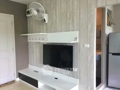 Modern living room with wall-mounted TV and sleek storage unit