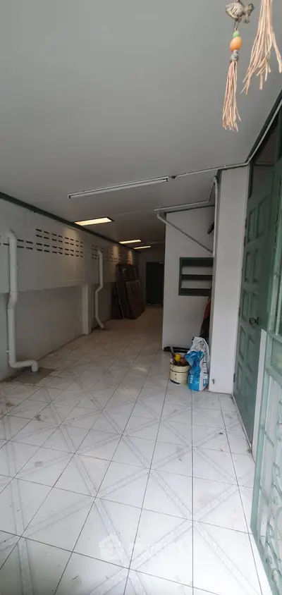 Spacious storage area with tiled flooring and ample shelving space.