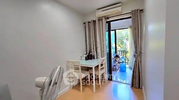 Cozy dining area with balcony view and air conditioning