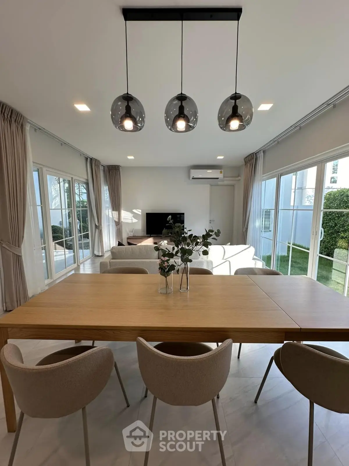 Modern living room with elegant dining area and large windows for natural light
