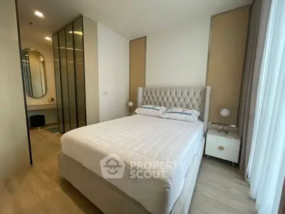 Modern bedroom with elegant decor and ample natural light