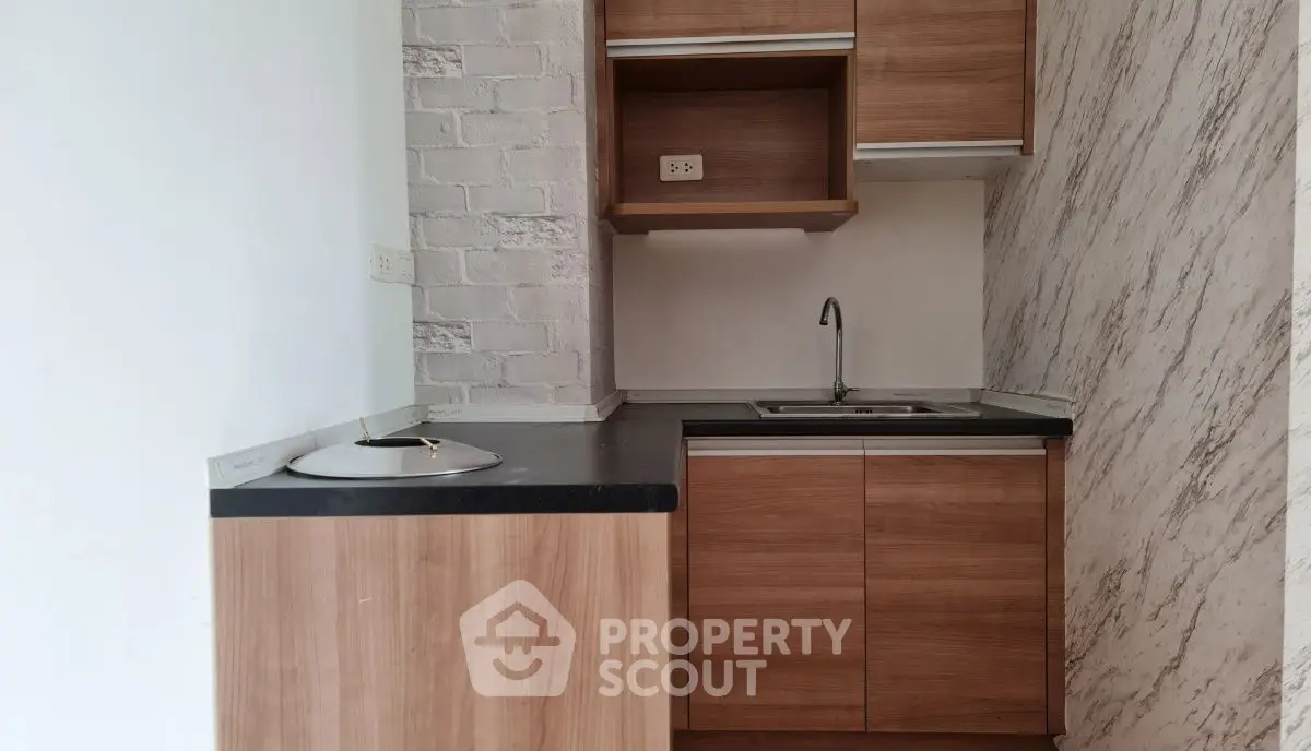 Compact kitchen with wooden cabinets and modern design