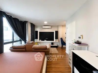Modern studio apartment with stylish decor and large windows for natural light.