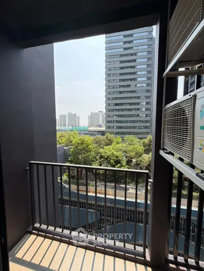 Modern balcony with city view and air conditioning unit, perfect for urban living.