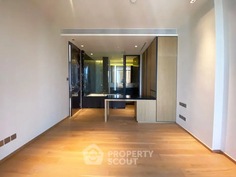 Spacious modern living room with wooden flooring and sleek design elements.