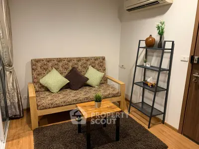 Cozy living room with stylish sofa, air conditioning, and modern decor