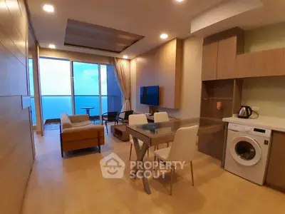 Modern living room with ocean view, open layout, and stylish furniture