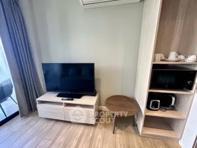 Modern living room with TV, wooden furniture, and balcony view
