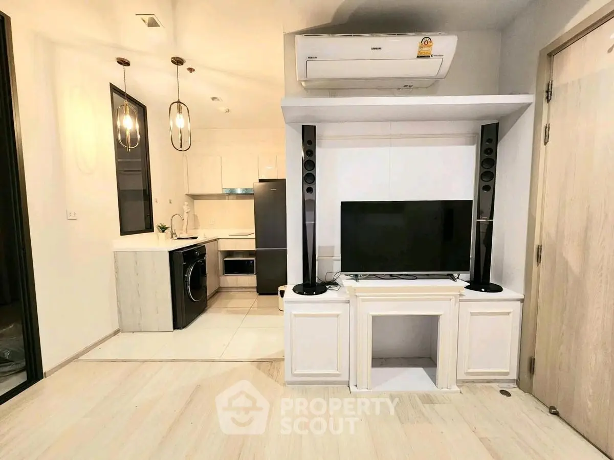 Modern living room with sleek kitchen and entertainment setup