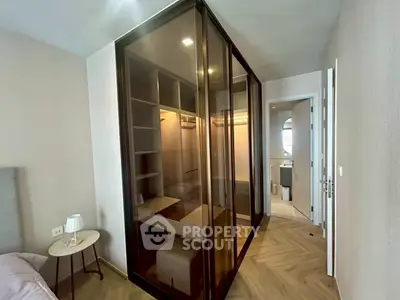 Modern bedroom with glass walk-in closet and elegant parquet flooring