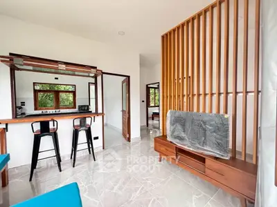 Modern open-plan living room with stylish wooden accents and breakfast bar in a bright, airy space.