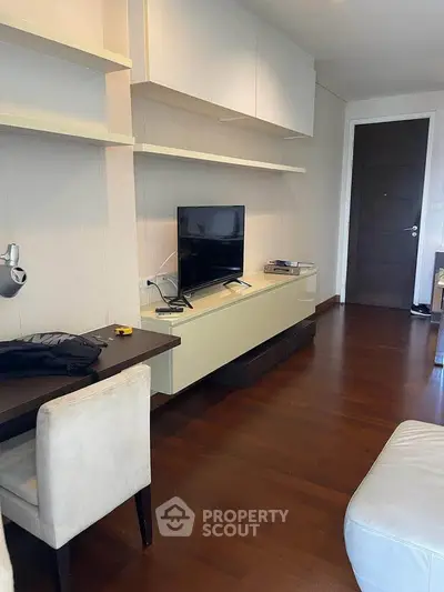 Modern living room with sleek TV setup and elegant wooden flooring