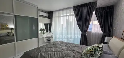 Modern bedroom with large window, elegant curtains, and stylish decor