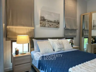 Cozy bedroom with elegant decor and plush bedding in modern apartment