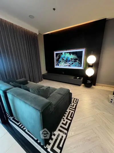 Luxurious living room with modern decor and large TV, perfect for entertainment and relaxation.
