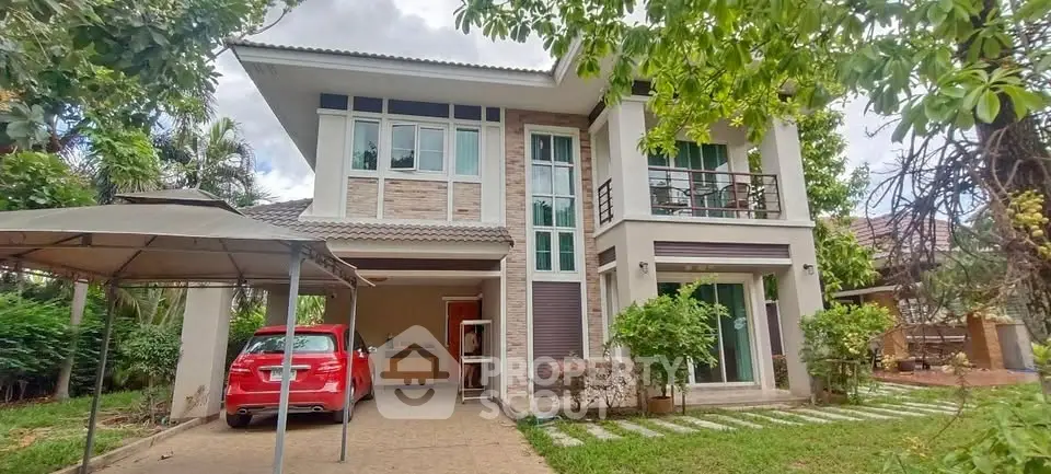 Stunning two-story house with carport and lush garden in serene neighborhood.