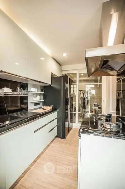 Modern kitchen with sleek cabinetry and gas stove in a stylish apartment.