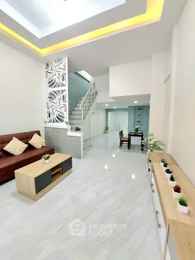 Spacious modern living room with elegant decor and open layout, perfect for family gatherings.