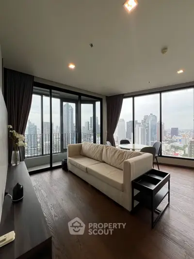Spacious living room with panoramic city views and modern decor.