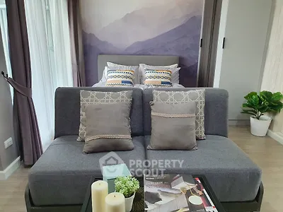 Stylish modern bedroom with cozy sofa and elegant decor, perfect for relaxation and comfort.