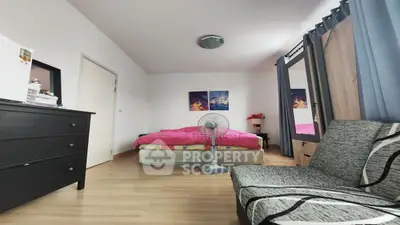 Cozy bedroom with modern decor and ample natural light