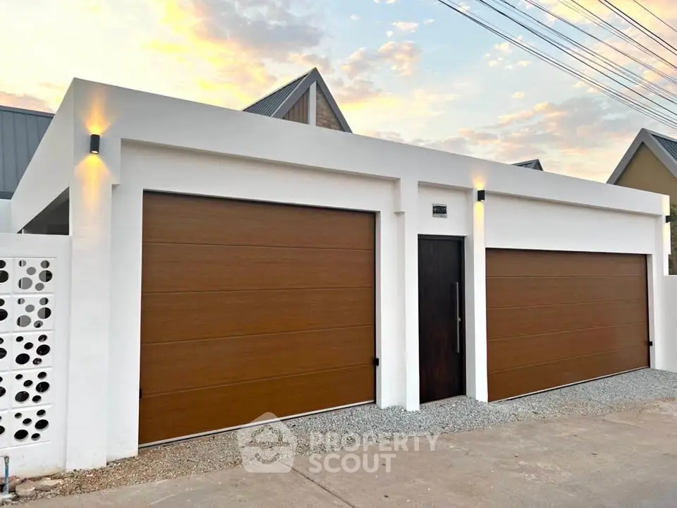 Modern minimalist garage exterior with dual wooden doors and sleek lighting
