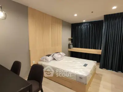 Modern bedroom with stylish decor and natural light, featuring a comfortable bed and elegant furnishings.