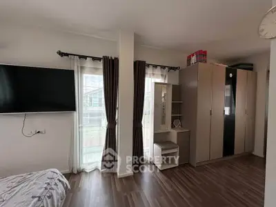 Spacious bedroom with modern wardrobe and large window view