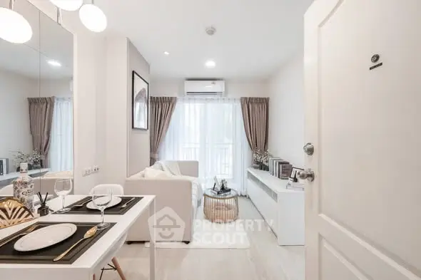 Modern living room with elegant decor and natural light, featuring a cozy dining area and stylish furnishings.