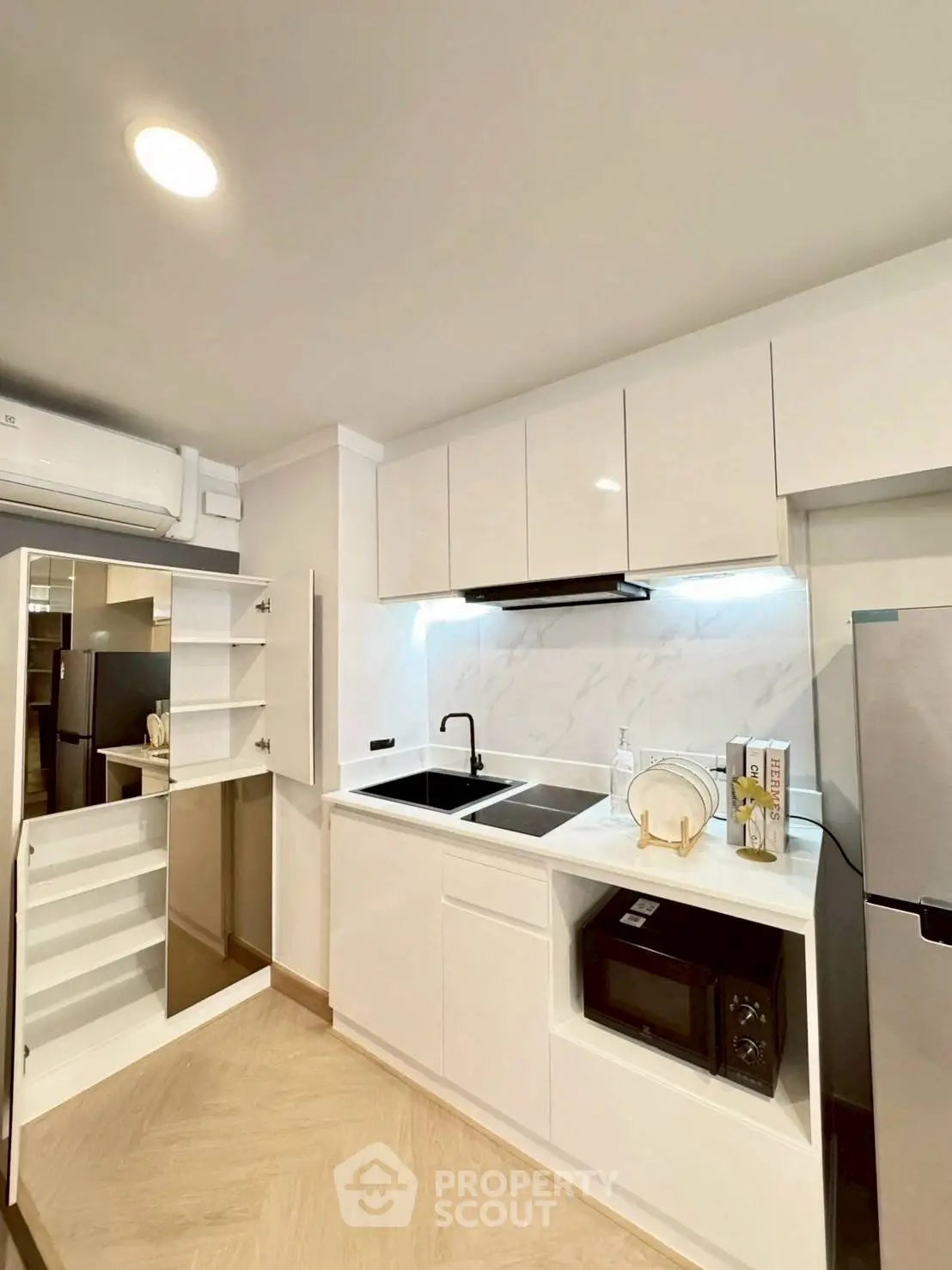 Modern kitchen with sleek white cabinets and built-in appliances