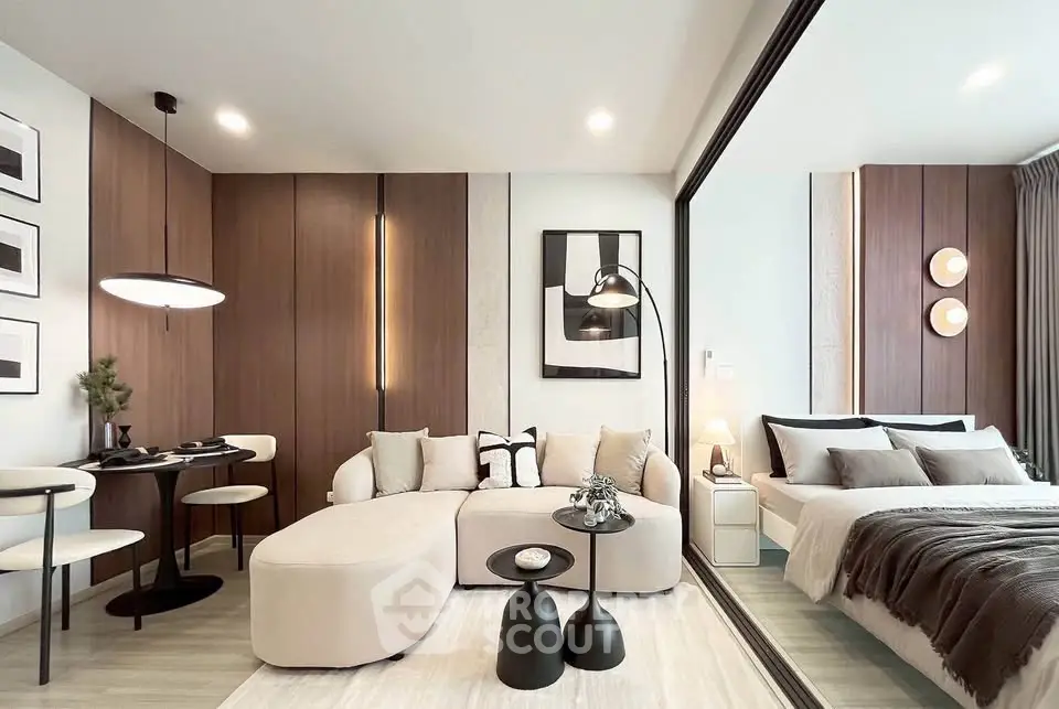 Modern open-plan living room and bedroom with stylish decor and wooden accents