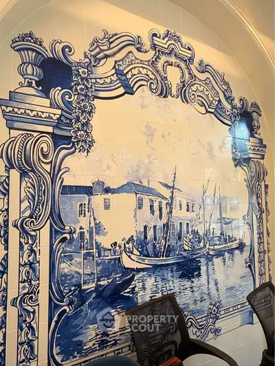 Elegant wall art with intricate blue and white tile design in a luxurious setting.