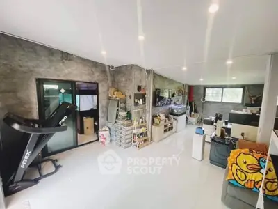 Spacious modern living room with treadmill and stylish decor
