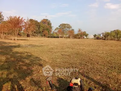 Expansive land plot with lush greenery and clear skies, ideal for development or agriculture.