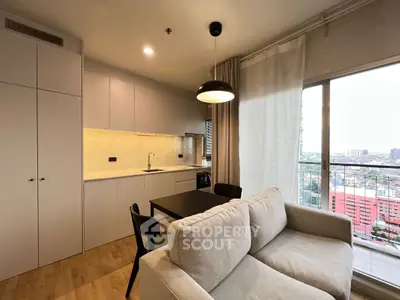 Modern open-plan living room with kitchen and city view balcony