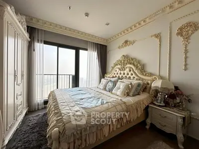 Luxurious bedroom with ornate bed and large window offering stunning views.