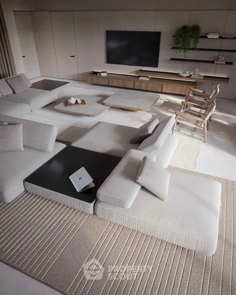 Luxurious modern living room with stylish furniture and large TV setup, perfect for relaxation.