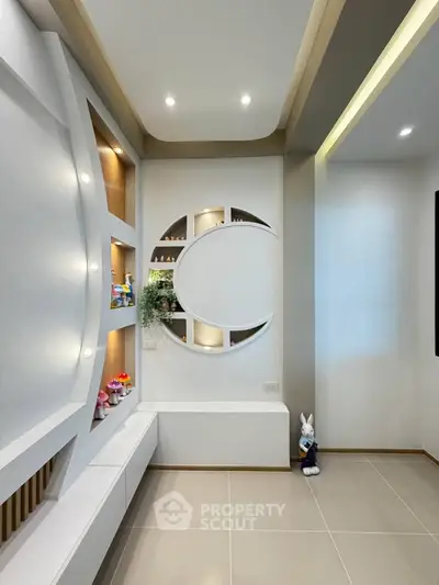 Modern interior with unique wall design and decorative shelves in a stylish living space.
