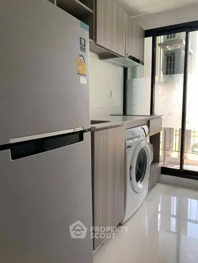 Modern kitchen with sleek appliances and ample natural light