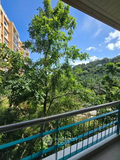 Stunning balcony view with lush greenery and blue skies, perfect for nature lovers.