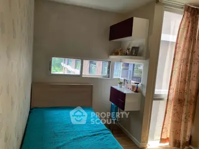 Cozy bedroom with natural light and modern shelving in urban apartment