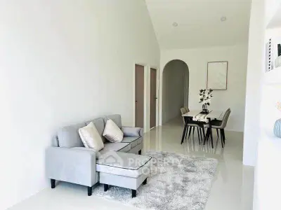 Modern living room with sleek furniture and elegant dining area