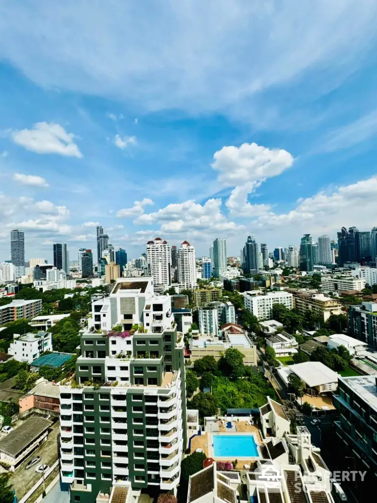 Stunning cityscape view from high-rise apartment with clear blue sky