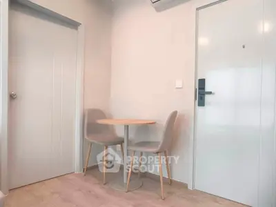 Cozy corner with modern chairs and table in minimalist interior design.