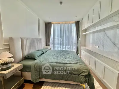 Luxurious bedroom with elegant decor and city view, featuring a plush bed and modern furnishings.